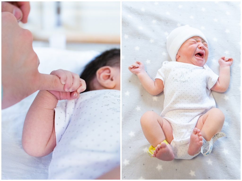 baby holding dad's finger